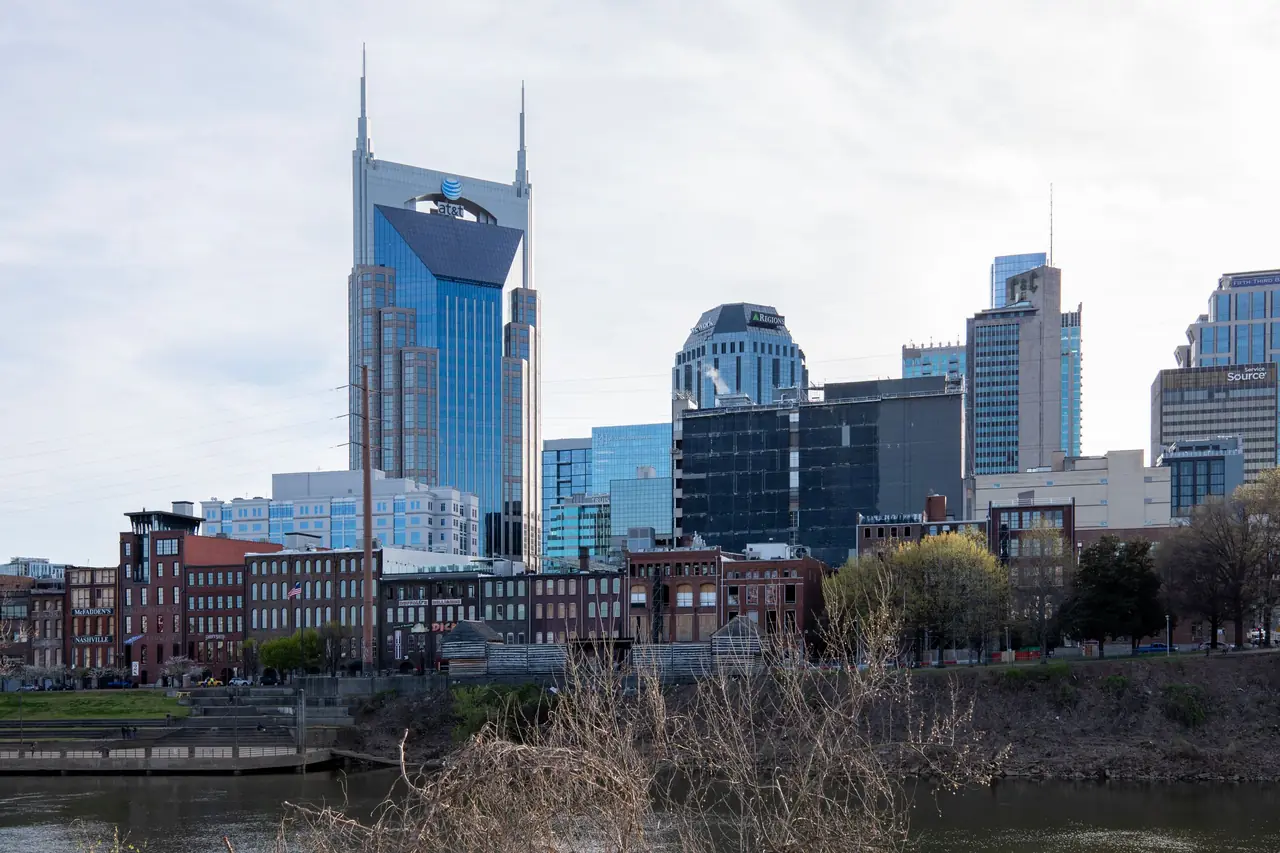 Nashville's skyline across the Cumberland River, with the twin-spired AT&T Building above the riverfront's historic brick buildings